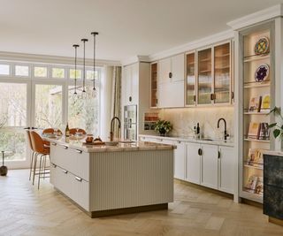 a neutral kitchen with a reeded detail on the kitchen island