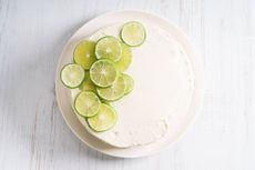 lemon and lime cake topped with slices of fresh lime