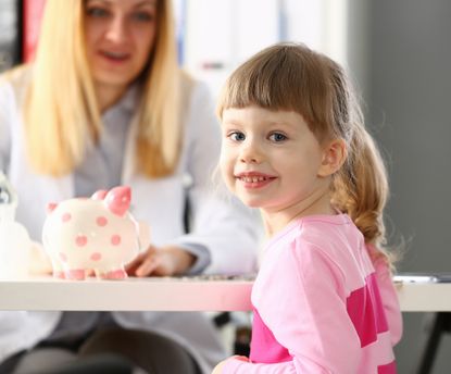 Mum and child with piggy bank