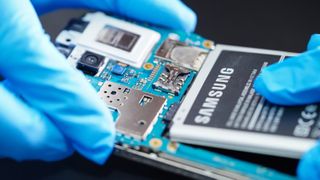 Technician attaching Samsung battery to smartphone