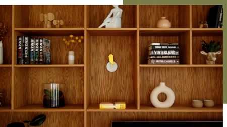 Image of a yellow Birdie product in a modern wooden bookcase