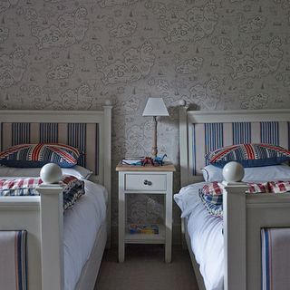 childrens bedroom with map wallpaper and twin beds