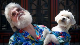 Man and dog wearing matching shirts