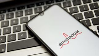 Broadcom logo on a smartphone lying on a laptop