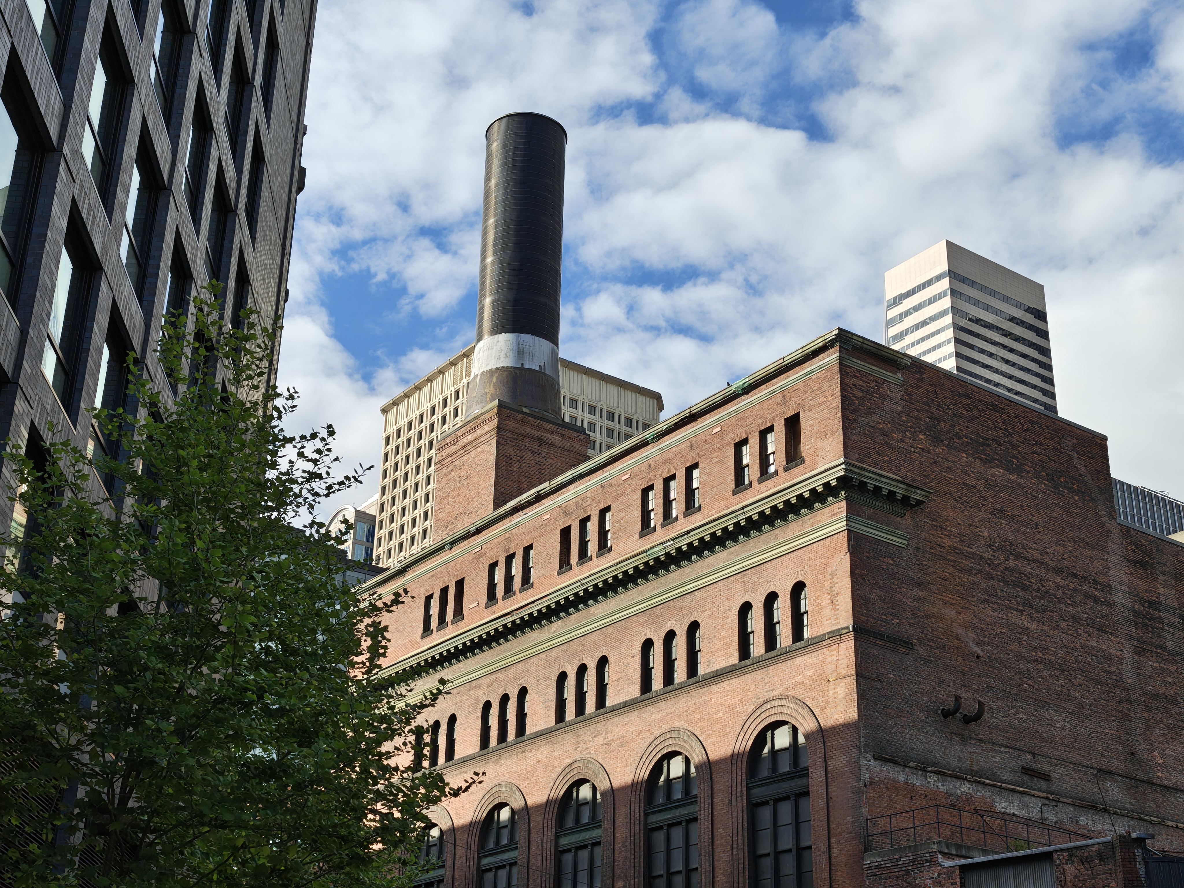 A brick building with a smokestack on top