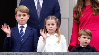Prince George of Cambridge, Princess Charlotte of Cambridge and Prince Louis of Cambridge stand on the balcony of Buckingham Palace