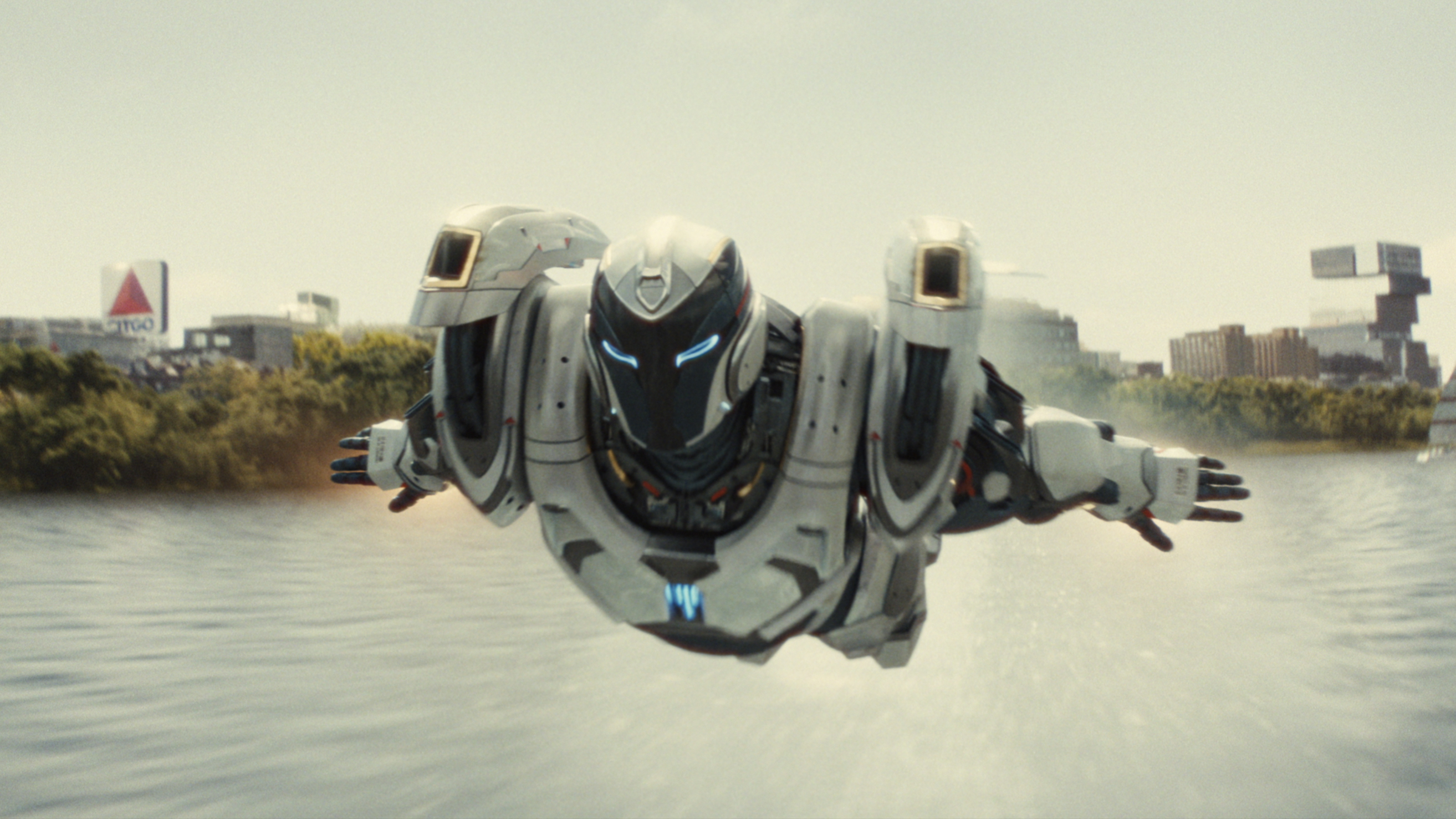 Riri Williams (Dominique Thorne) flies across a river in the Ironheart suit in a scene from Marvel&#039;s &quot;Ironheart&quot; tv show