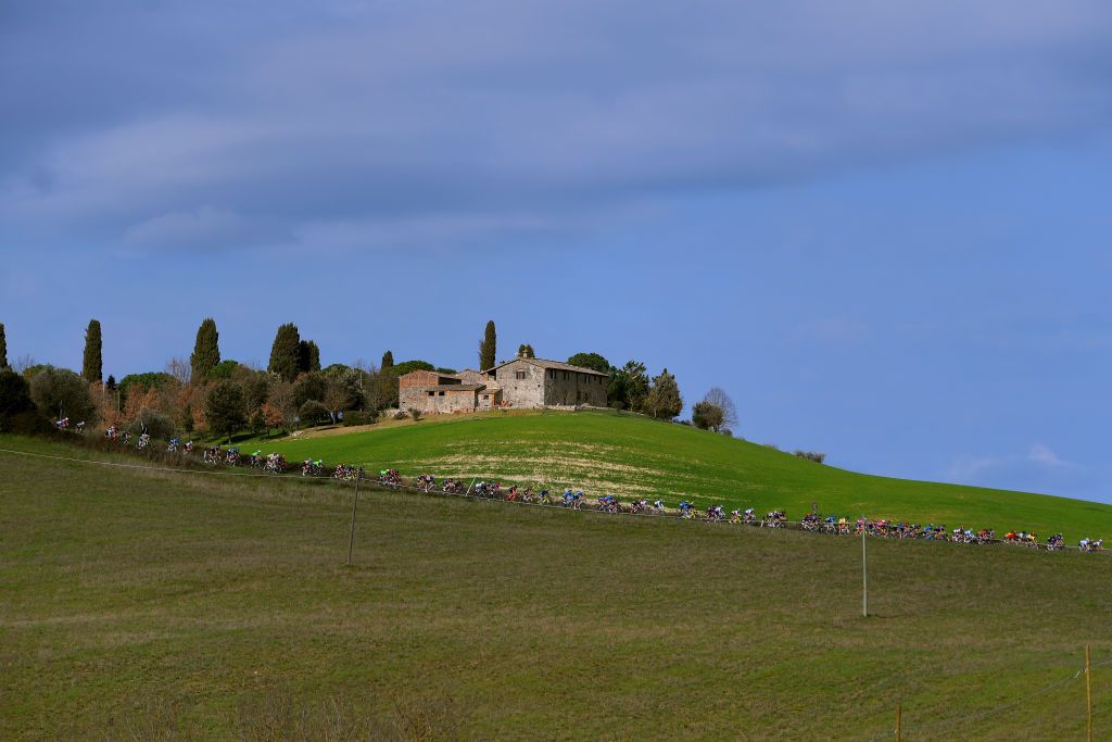 SIENA ITALY MARCH 06 The Peloton passing through Tuscany landscape during the Eroica 7th Strade Bianche 2021 Womens Elite a 136km race from Siena to Siena Piazza del Campo StradeBianche on March 06 2021 in Siena Italy Photo by Luc ClaessenGetty Images