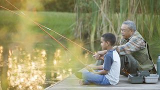 Research reveals mental health benefits of being in nature, and how to use it more: a grandfather teaches his grandson how to fish