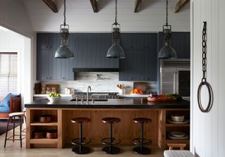 kitchen with large island and bar stools and black wood cabinets