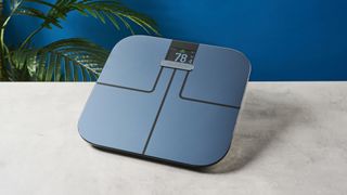 A Garmin Index S2 smart scale on a hard surface