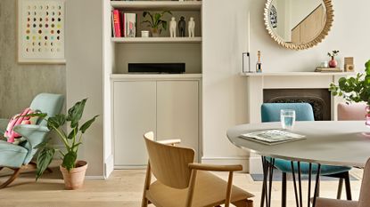 room with wooden chair potted plant and mirror