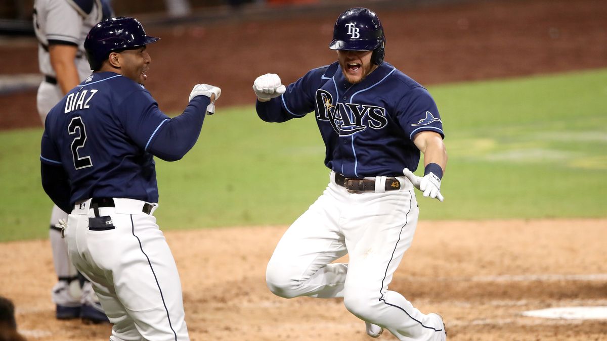 Ray&#039;s Michael Brosseau celebrates with Yandy Diaz after hitting a solo home run in the ALDS.