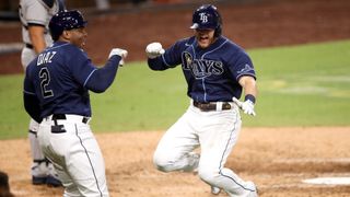 Ray's Michael Brosseau celebrates with Yandy Diaz after hitting a solo home run in the ALDS.