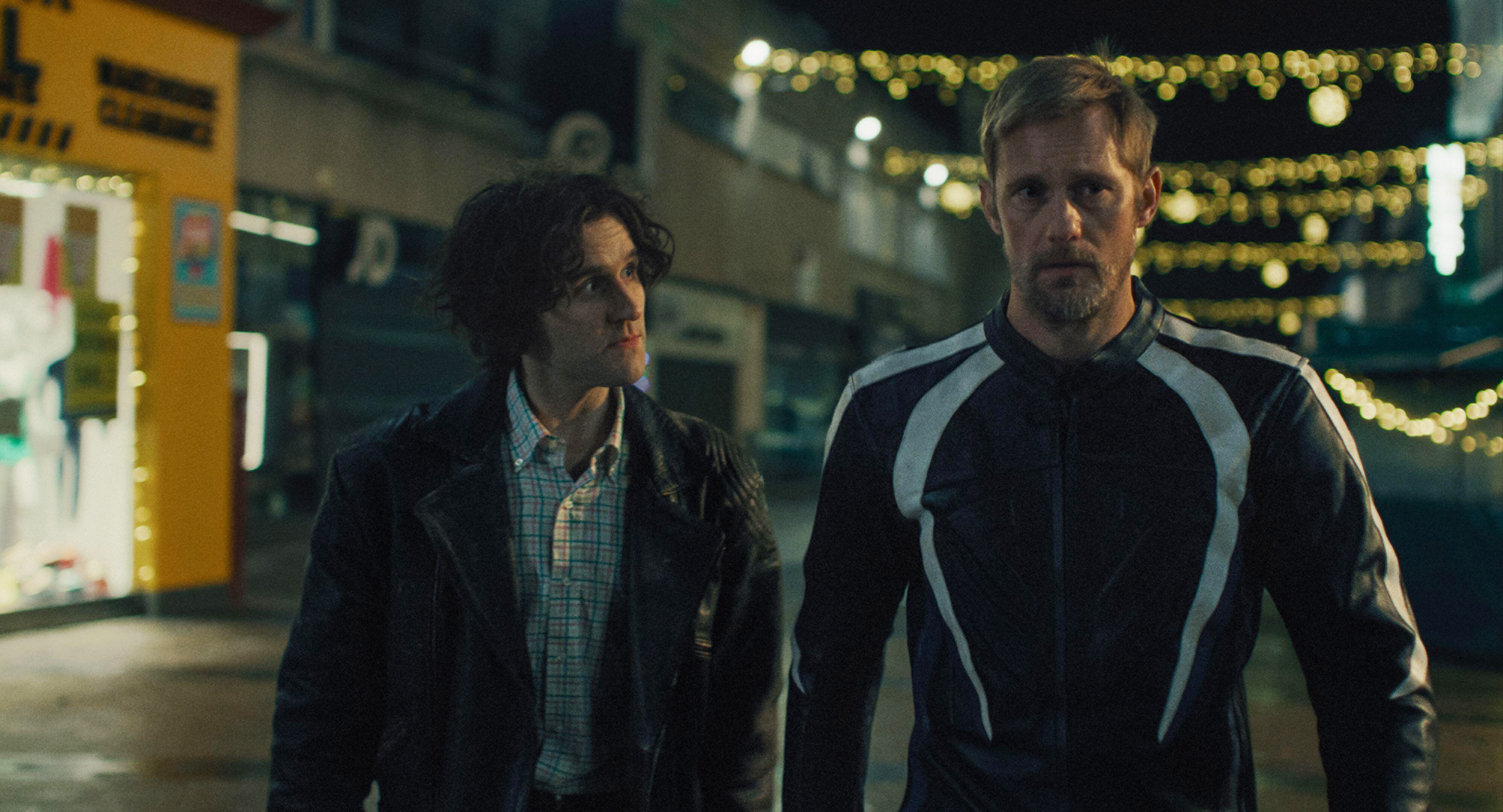 Film still from 'Pillion' showing Alexander Skarsgard and Harry Melling side by side