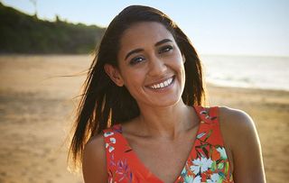Josephine Jobert smiling as DS Florence Cassell in Death in Paradise