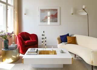 a modern living room with a red chair