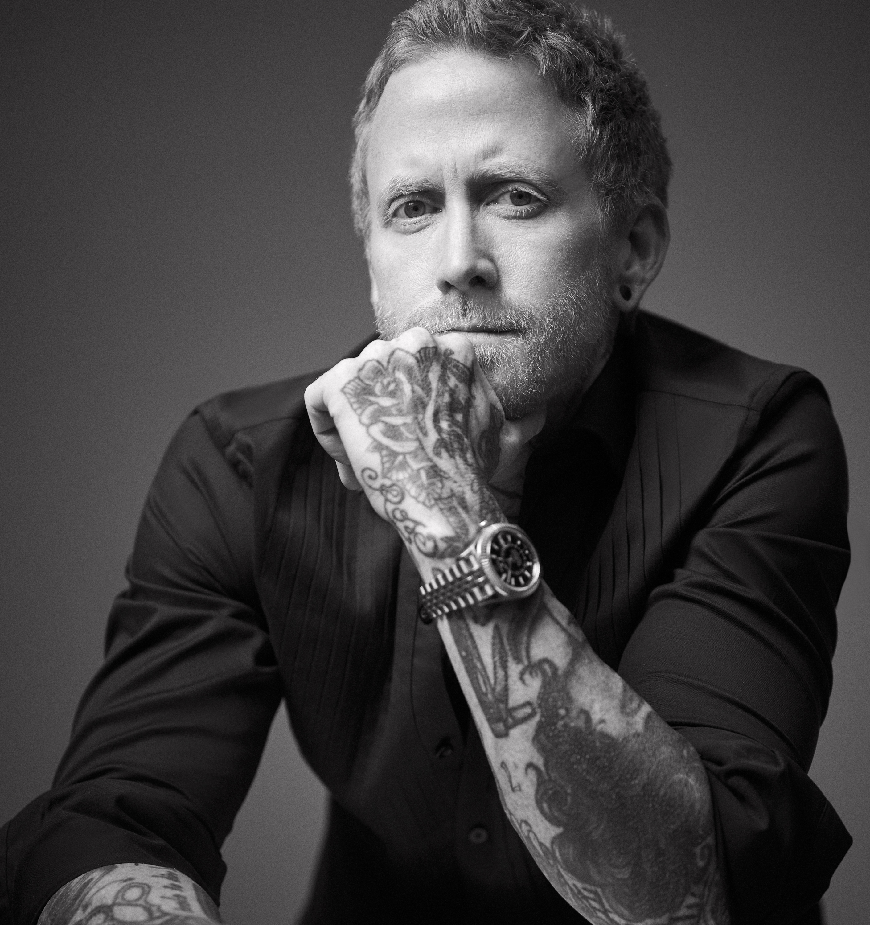 Aaron Grenia poses for a black and white headshot.