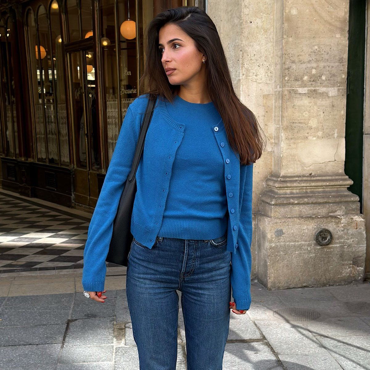 Parisian woman in a blue sweater and jeans