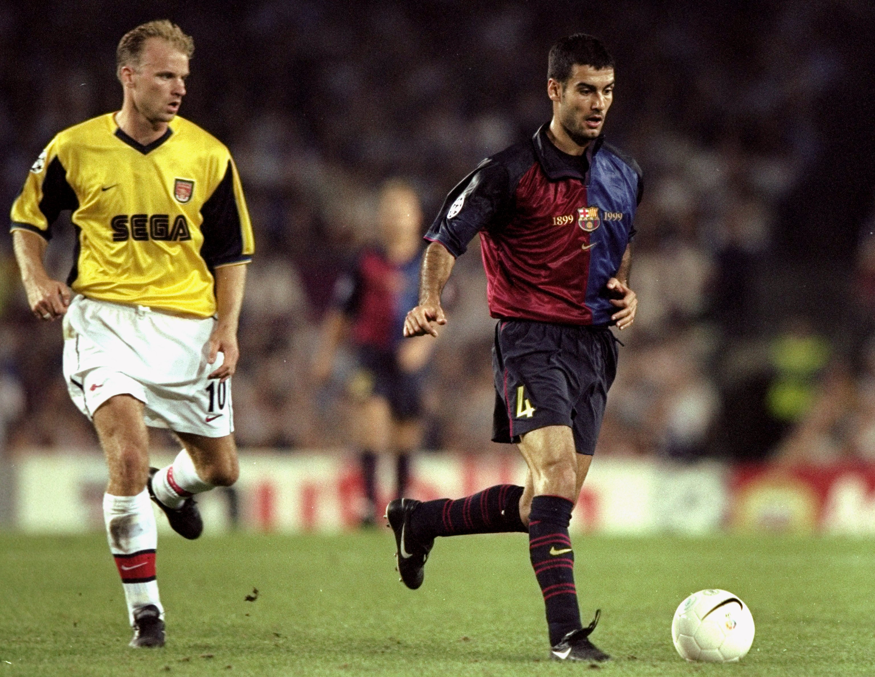 Barcelona midfielder Pep Guardiola on the ball against Arsenal as Dennis Bergkamp gives chase in a Champions League game in 1999.