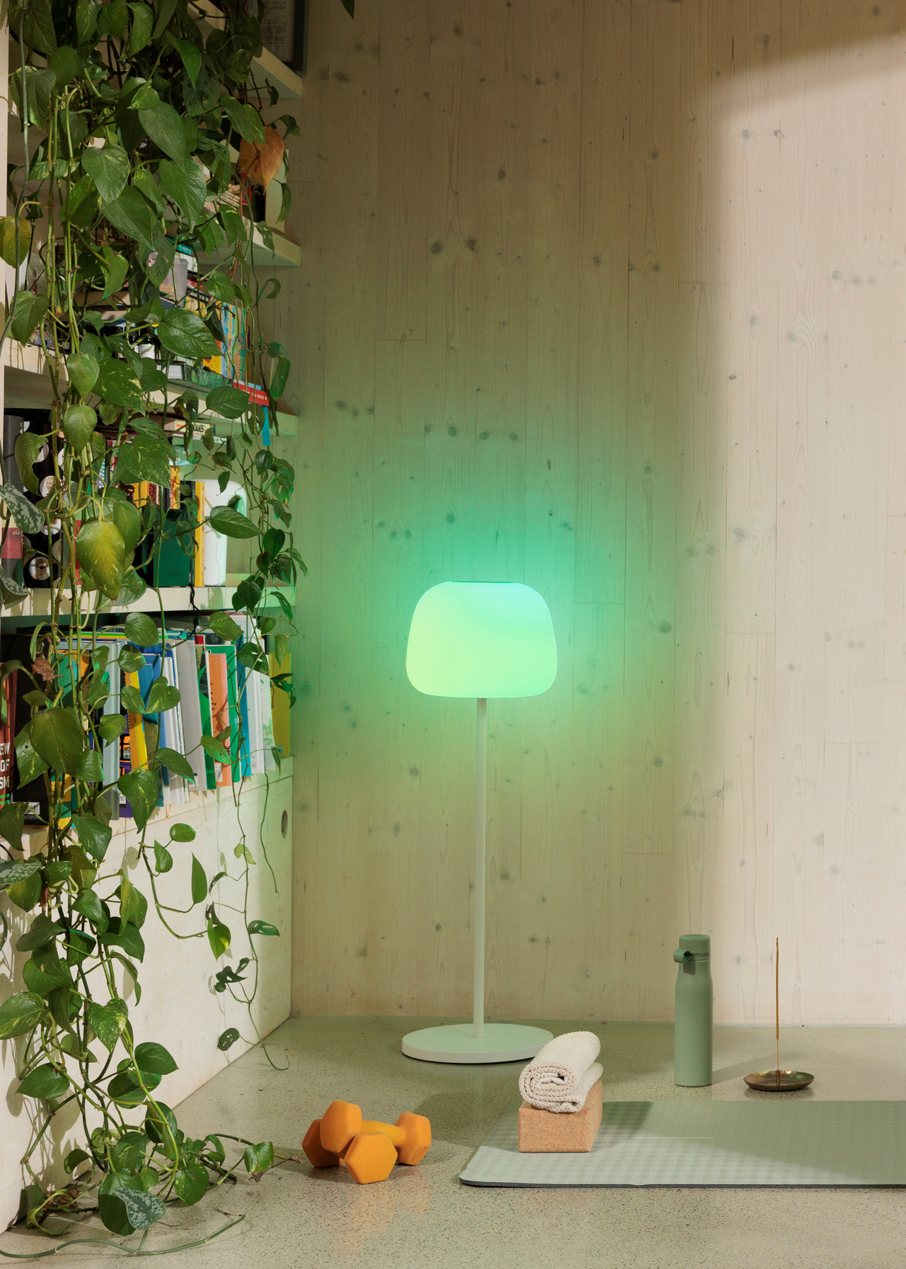 A calming green lamp in a workout space from Govee