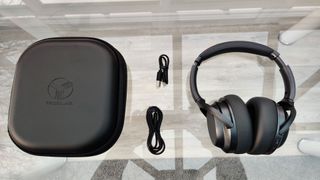 Image shows the Treblab Z7 Pro headphones next to their case and cables.