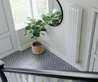 White vertical column radiator with a black and white diamond patterned floor