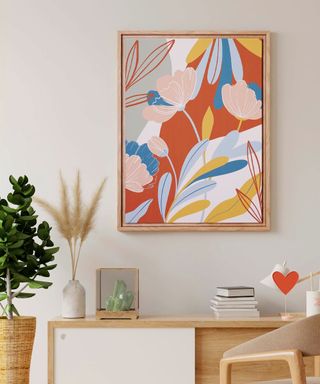 Colorful floral artwork in wooden frame, mounted on wall