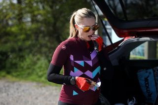 Female cyclist fuelling before going on a bike ride