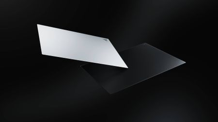 Two Razer Atlas Pro glass mouse pads floating in the void.