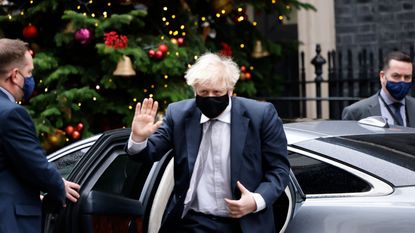 Boris Johnson gestures on his return to 10 Downing Street.