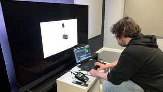 TechRadar reviewer measuring TV color gamut coverage with test equipment