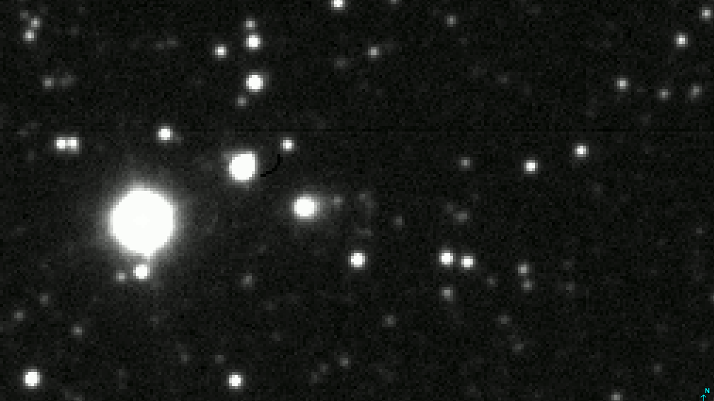 Looped video footage of a comet moving across a starscape in telescope images