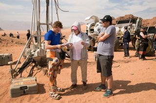 Ridley Runs Lines With Matt: Director and lead actor confer on location in the Jordanian desert.