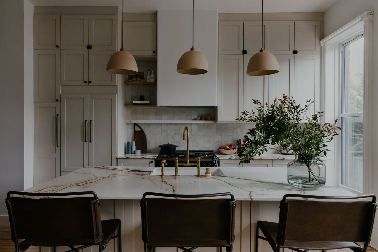 A neutral kitchen space with marble island