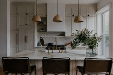 A neutral kitchen space with marble island
