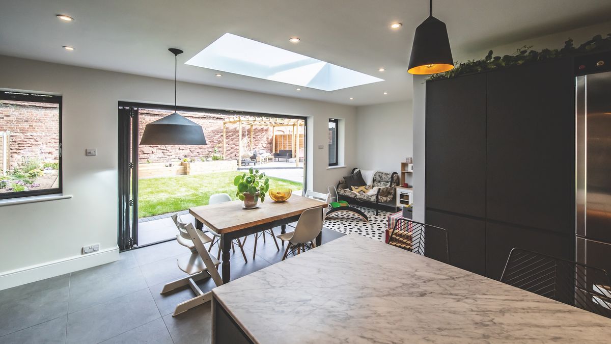 The extension is punctuated with light thanks to a roof lantern and bifold doors that create a much-needed connection with the garden.