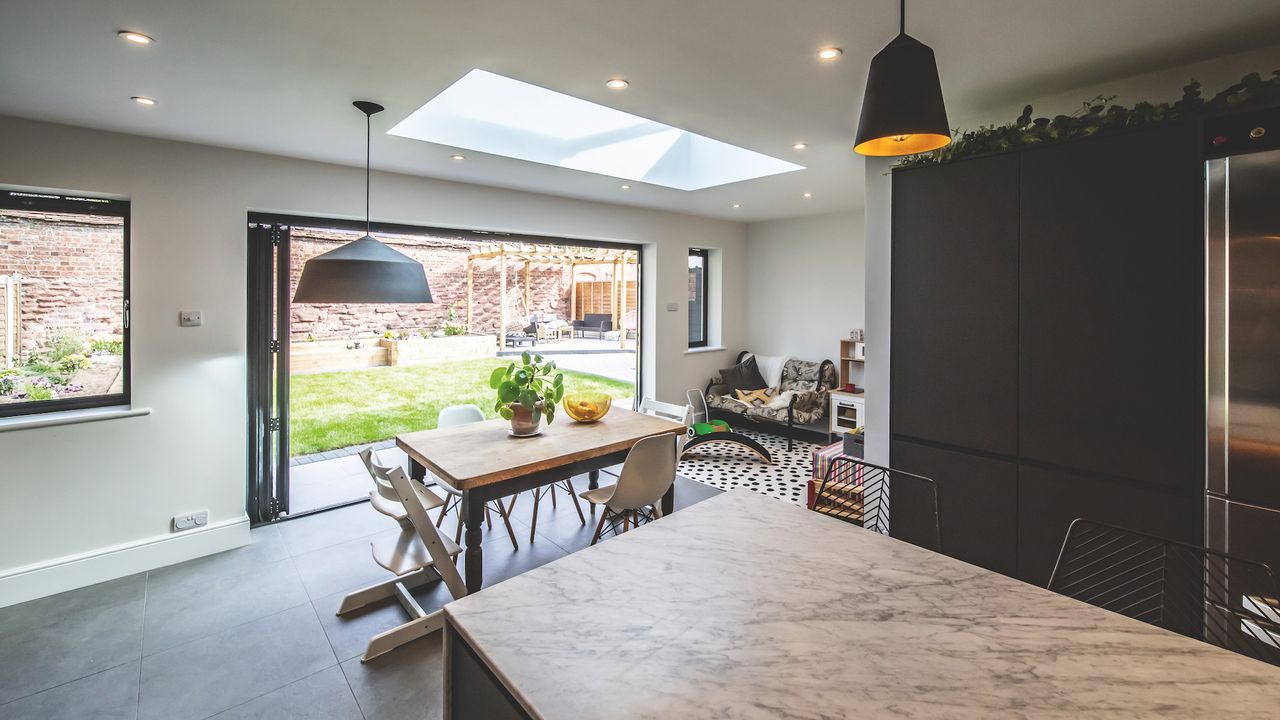 The extension is punctuated with light thanks to a roof lantern and bifold doors that create a much-needed connection with the garden.