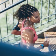 25-7-2 workout: A woman on a stairmaster machine at the gym