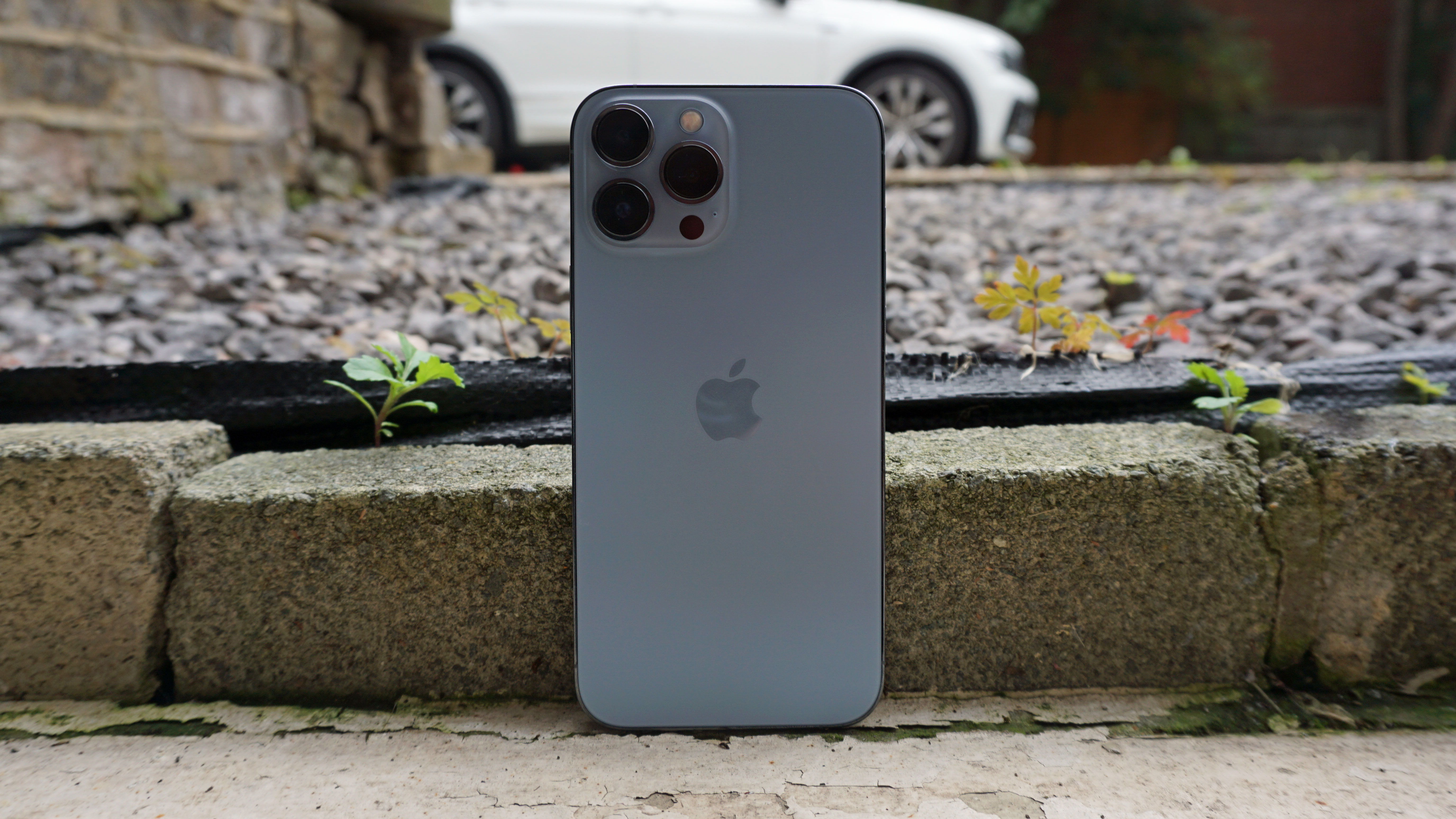 An iPhone 13 Pro Max outside, viewed from the back