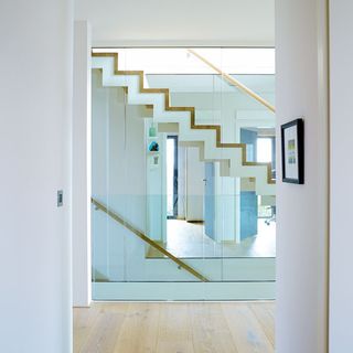 hallway with glass partition and wooden floor