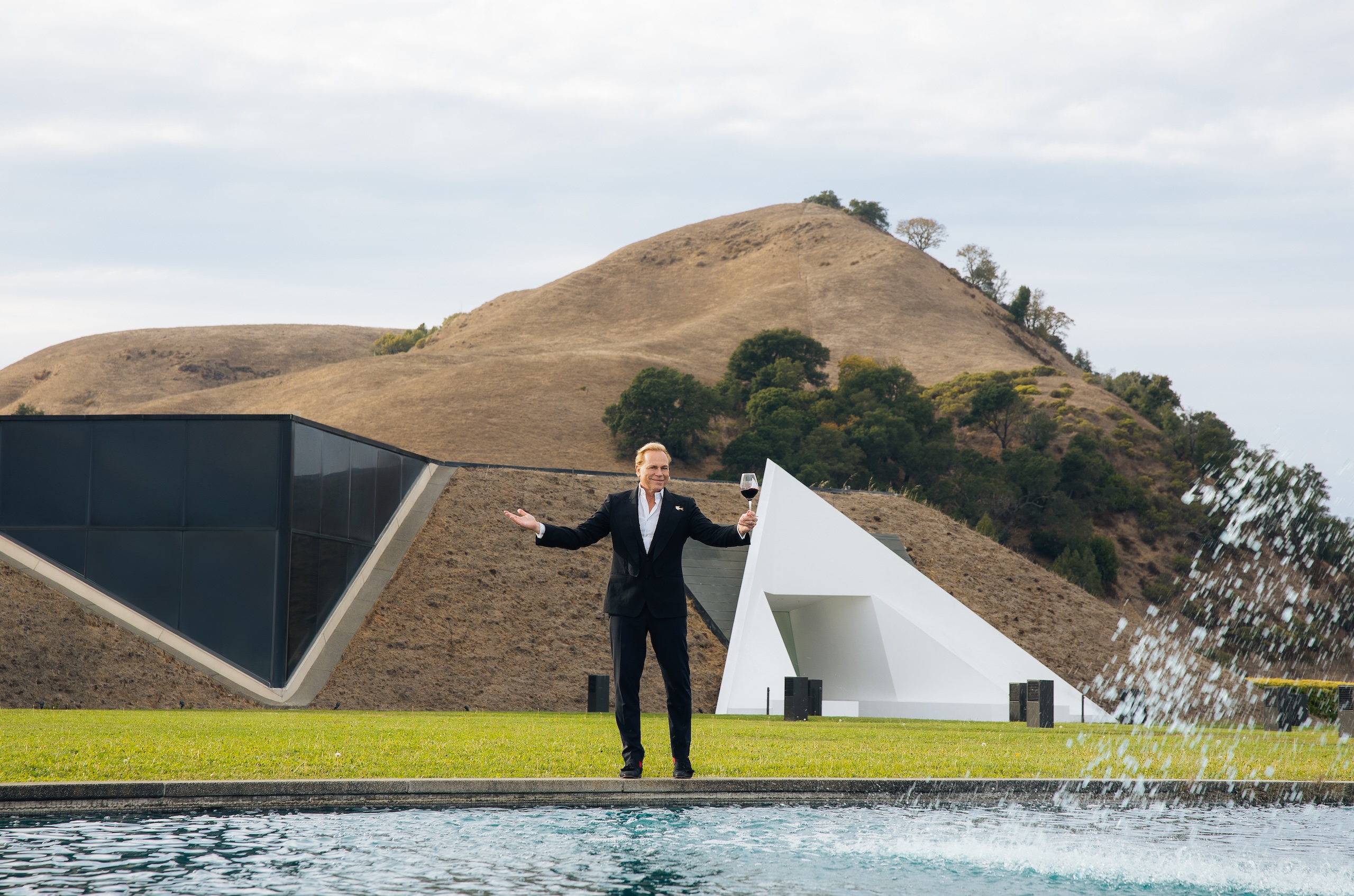 Jean-Charles Boisset standing outside of newly acquired Artesa winery next to the pool