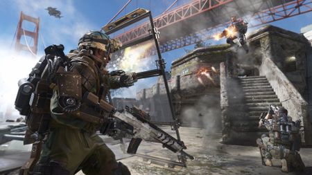 Advanced Warfare: A soldier using a riot shot to block gunfire from another player jumping from a staircase with dual-wield machine guns.