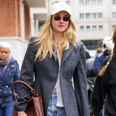 Shailene Woodley wears a Fendi bag with a baseball hat during Milan Fashion Week