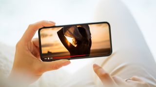 Woman watching YouTube on mobile phone screen