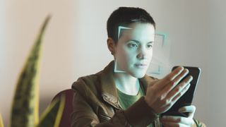 A person using a mobile device to verify their age via a facial scan