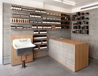 Aesop salon with products on shelf and sink