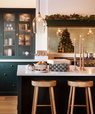 kitchen with dark green cabinets and cozy christmas decor