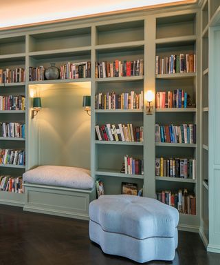 home library with a dedicated reading nook and comfortable ottoman