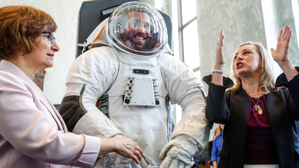 Rep. Suzanne Bonamici (D-OR), left, and Rep. Kendra Horn (D-OK), join an engineer inside the prototype of Collins Aerospace, a unit of United Technologies Corp.'s Next Generation Space Suit system, unveiled during the Space Day on the Hill on Thursday, July 25, 2019 in Washington. The showcase was timed to commemorate the 50th Anniversary of Apollo 11.